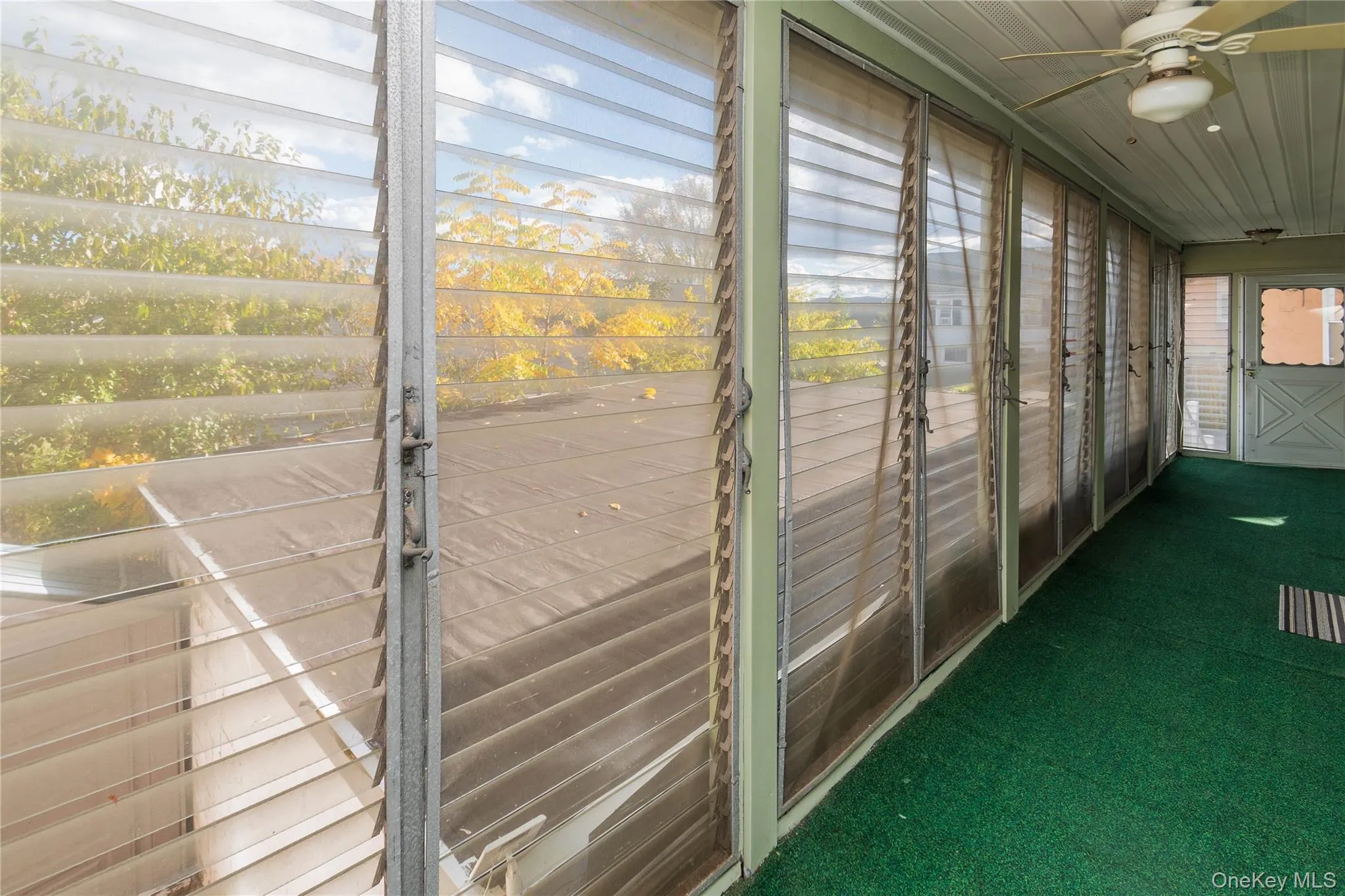Unfurnished sunroom with ceiling fan Unfurnished sunroom with ceiling fan