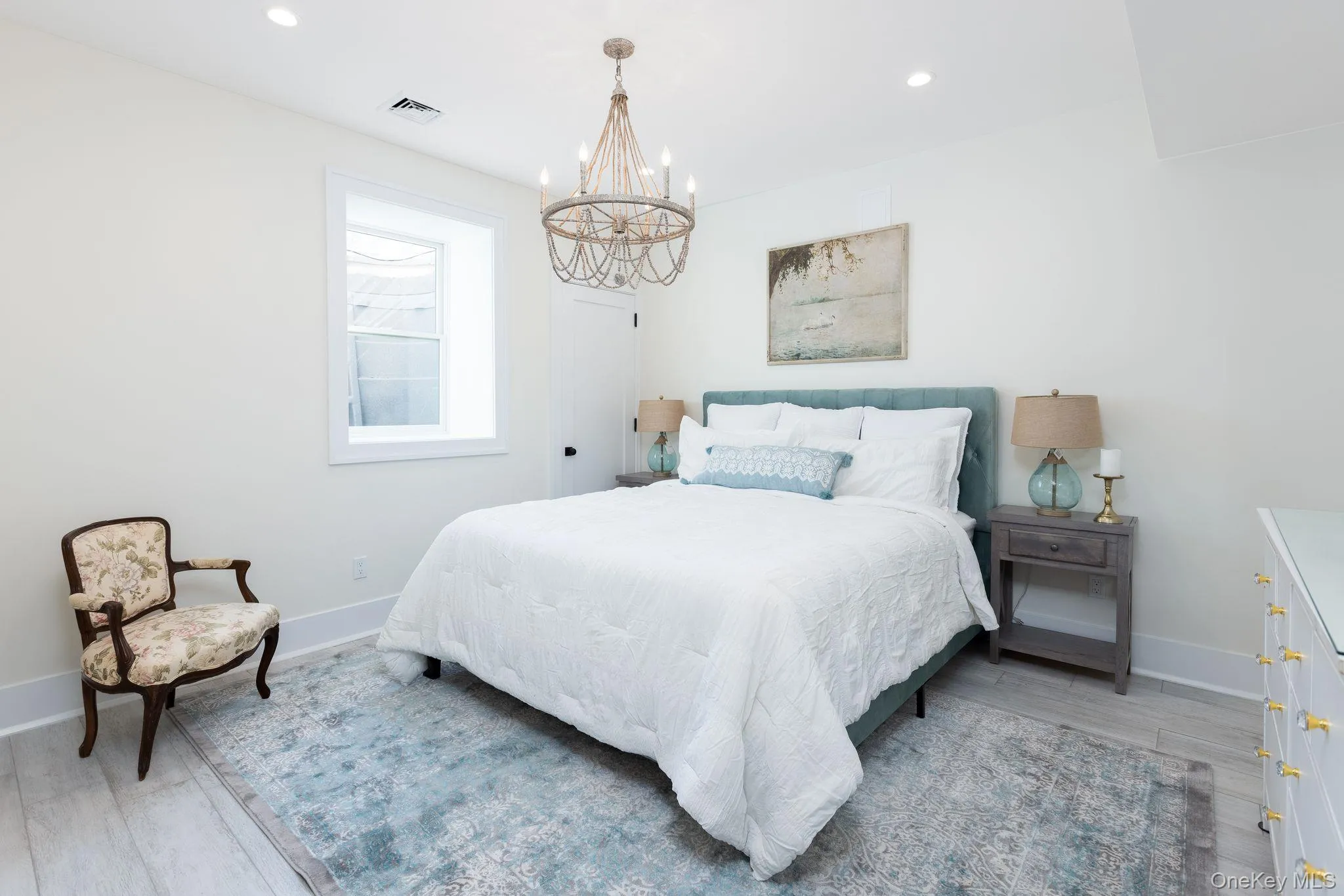 Bedroom with light wood-style floors, recessed lighting, and a chandelier Bedroom with light wood-style floors, recessed lighting, and a chandelier