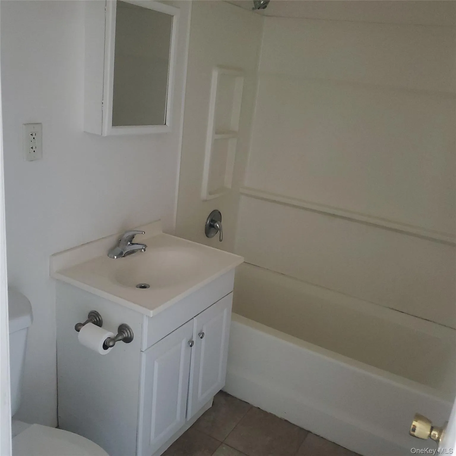 Bathroom with light tile patterned floors, vanity, and shower / bath combination Bathroom with light tile patterned floors, vanity, and shower / bath combination