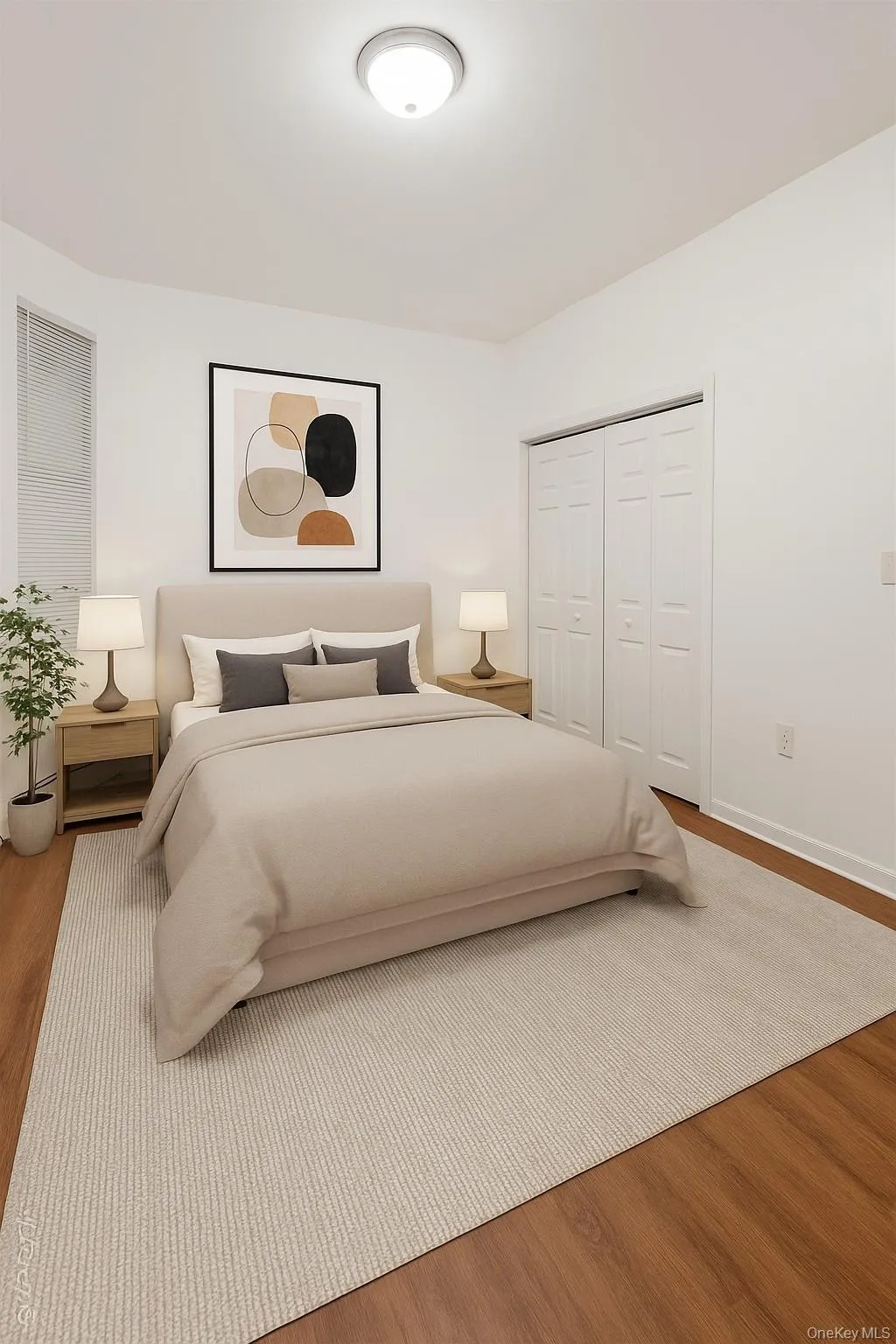 (Virtually staged) Bedroom featuring wood finished floors and a closet (Virtually staged) Bedroom featuring wood finished floors and a closet