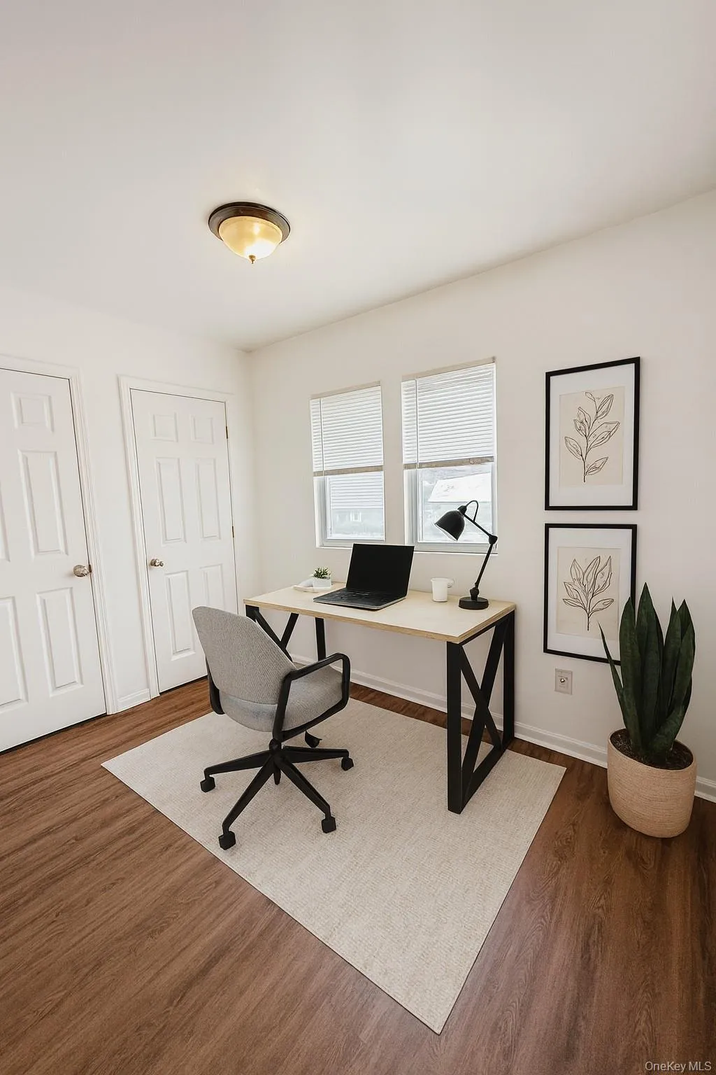(Virtually staged) Office area featuring dark wood-style flooring and baseboards (Virtually staged) Office area featuring dark wood-style flooring and baseboards
