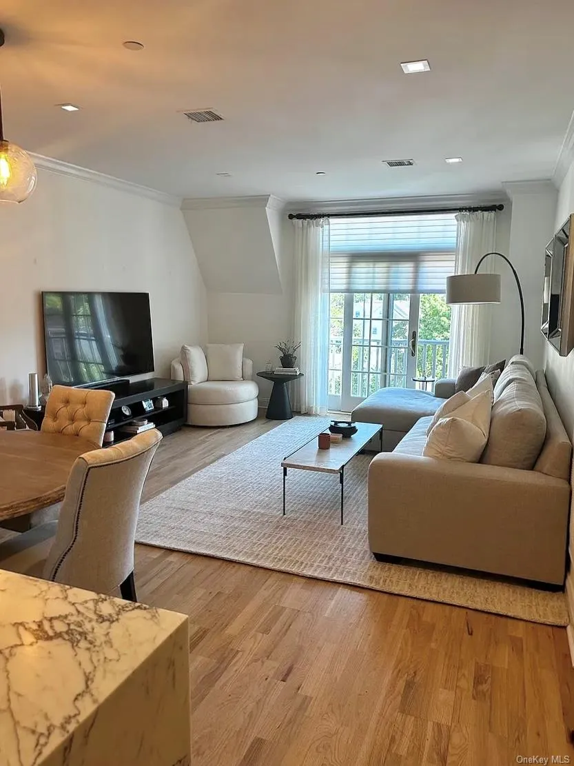 Living / Dining Room featuring crown molding, light wood-style flooring, and recessed lighting Living / Dining Room featuring crown molding, light wood-style flooring, and recessed lighting