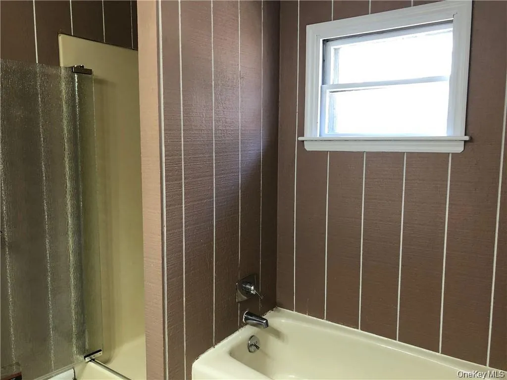 Bathroom featuring shower / washtub combination Bathroom featuring shower / washtub combination