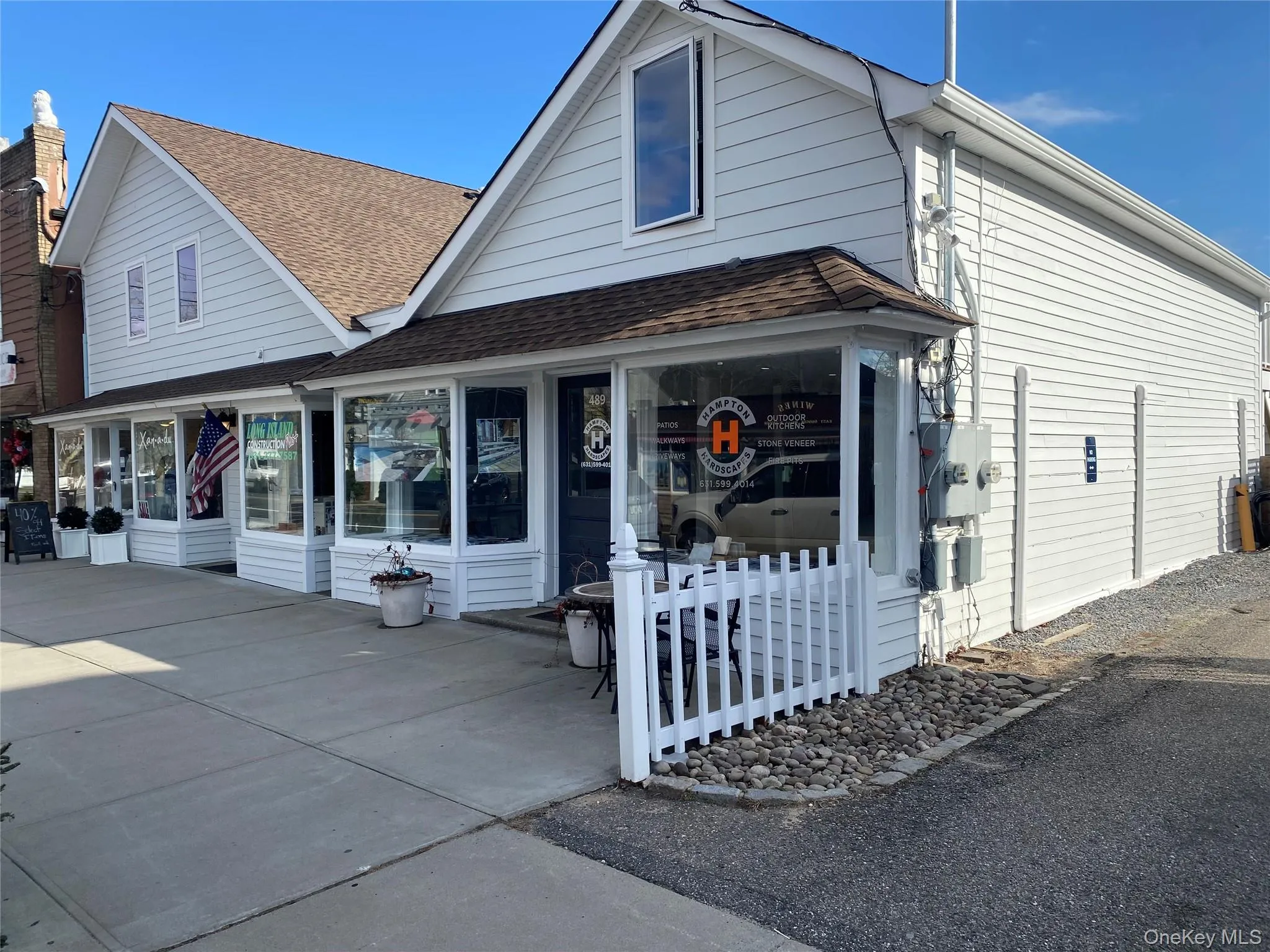View of front facade featuring a shingled roof View of front facade featuring a shingled roof