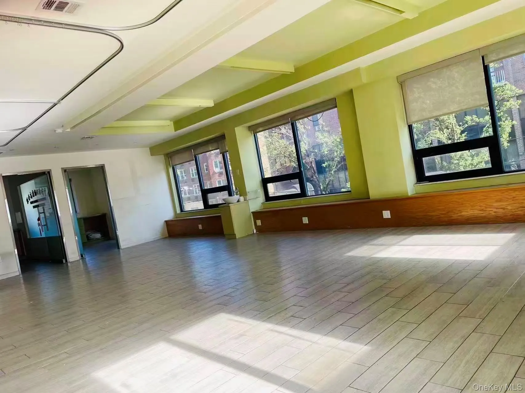 Empty room with wood finished floors and beamed ceiling Empty room with wood finished floors and beamed ceiling