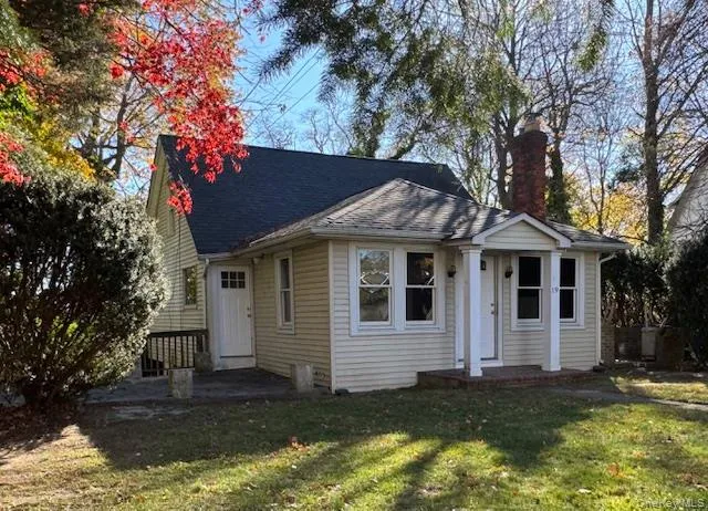 Bungalow-style home with a front lawn, a chimney, a shingled roof, and a patio area Bungalow-style home with a front lawn, a chimney, a shingled roof, and a patio area
