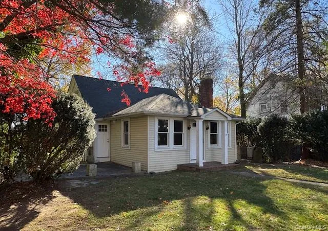 Rear view of house with a chimney, a yard, and a patio area Rear view of house with a chimney, a yard, and a patio area