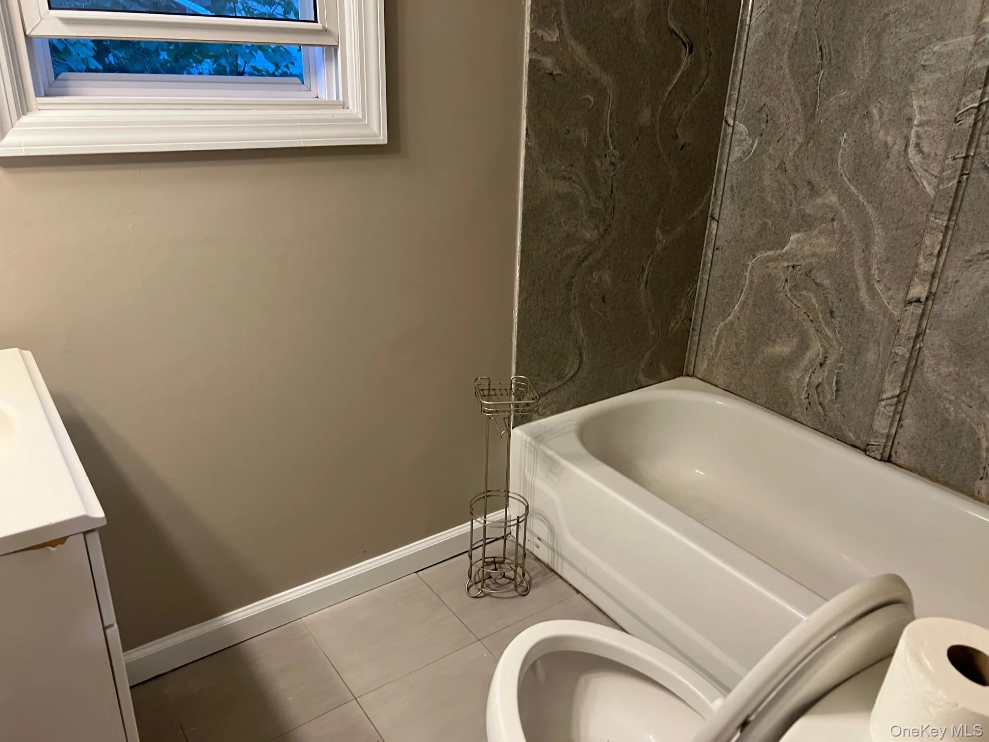 Full bath featuring vanity and tile patterned flooring Full bath featuring vanity and tile patterned flooring