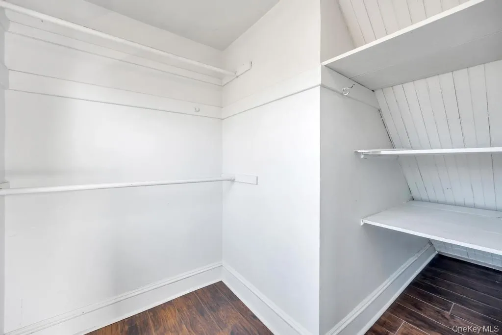 Walk in closet with dark wood-type flooring Walk in closet with dark wood-type flooring
