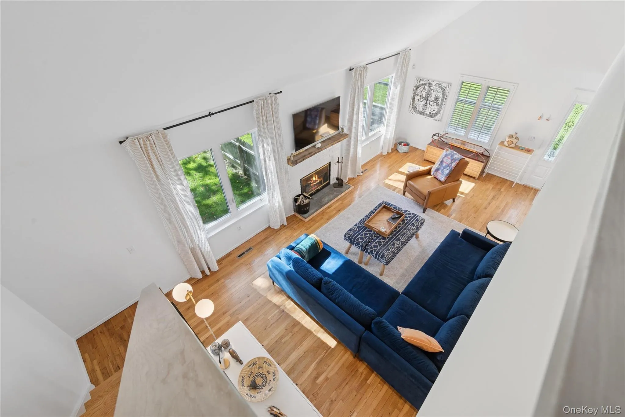 Living Room featuring a high ceiling, light plenty of natural light Living Room featuring a high ceiling, light plenty of natural light