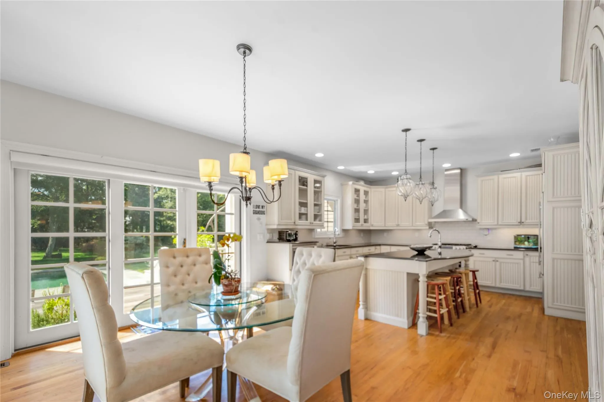 Dining area featuring a chandelier, light wood-style floors, and recessed lighting Dining area featuring a chandelier, light wood-style floors, and recessed lighting