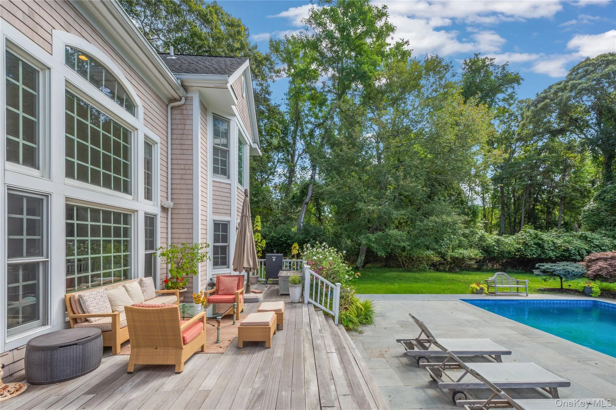 Deck with an outdoor living space, an outdoor pool, a patio area, and view of wooded area Deck with an outdoor living space, an outdoor pool, a patio area, and view of wooded area