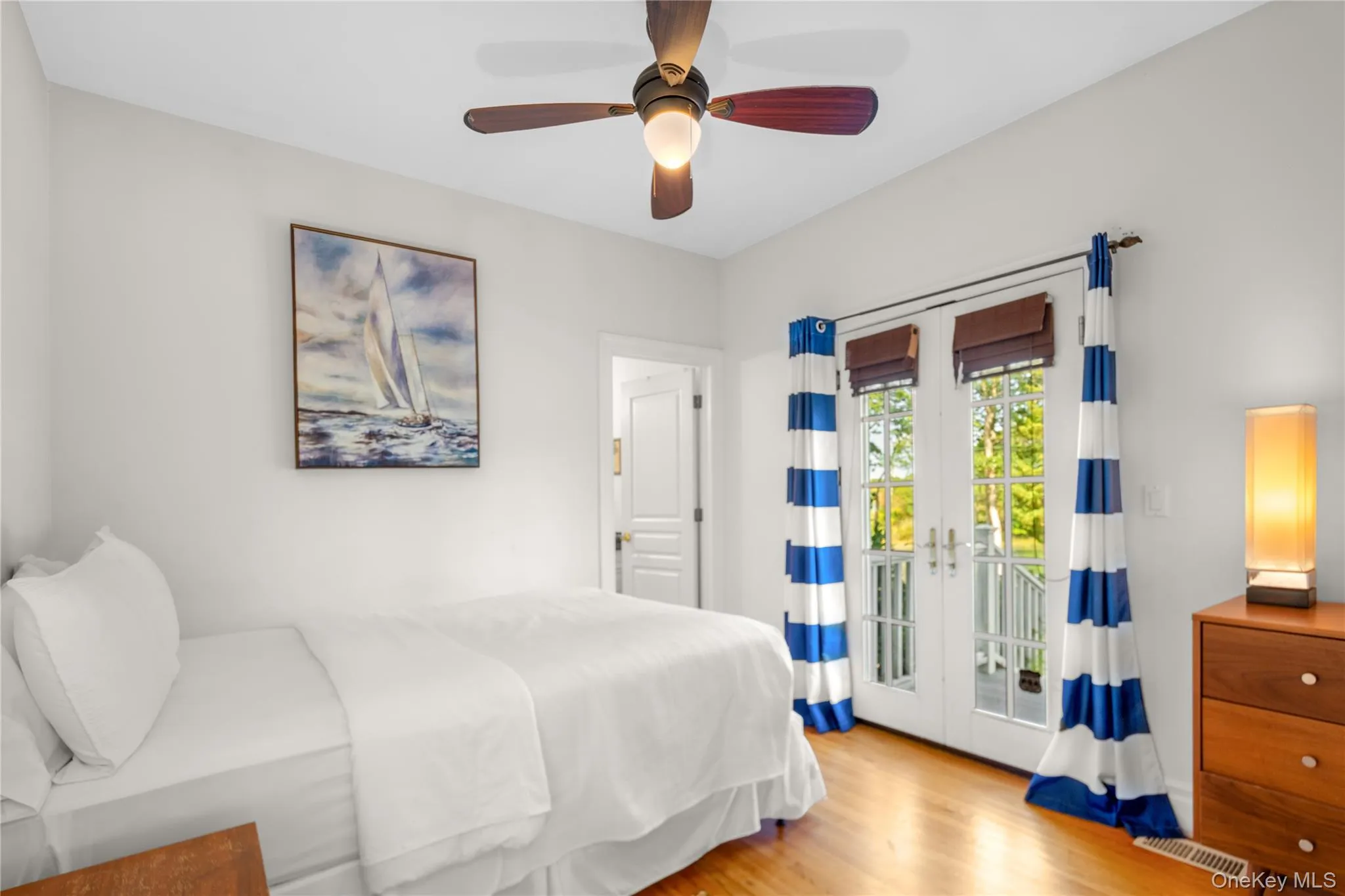 Bedroom with french doors, light wood-style flooring, access to outside, and ceiling fan Bedroom with french doors, light wood-style flooring, access to outside, and ceiling fan