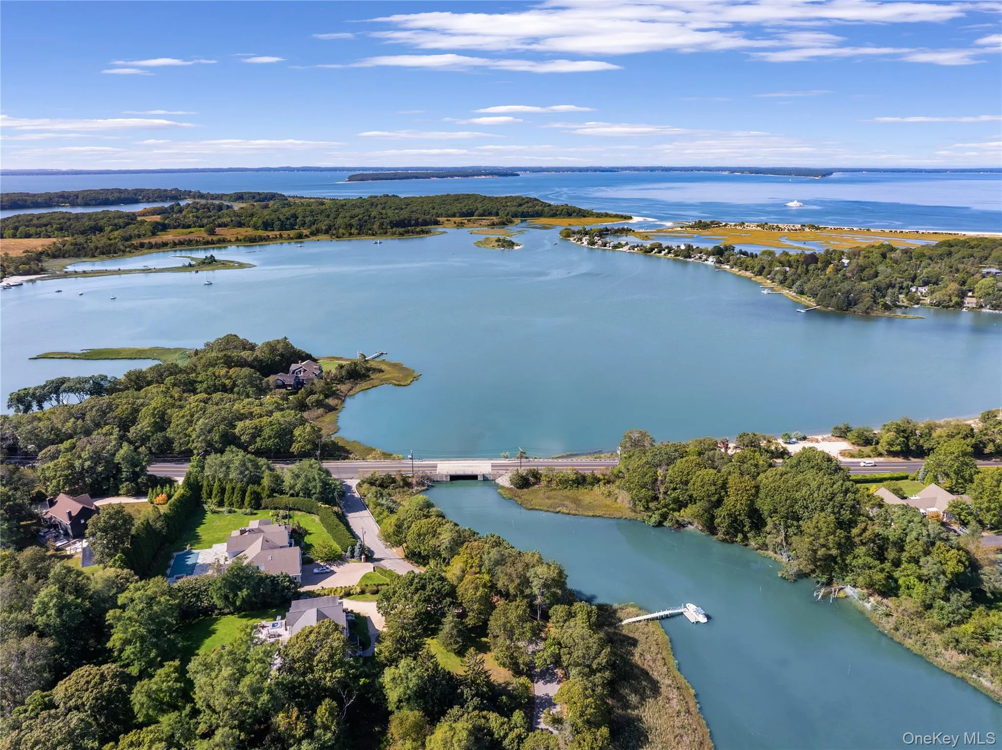 Drone / aerial view of a nearby body of water and a notable bridge Drone / aerial view of a nearby body of water and a notable bridge