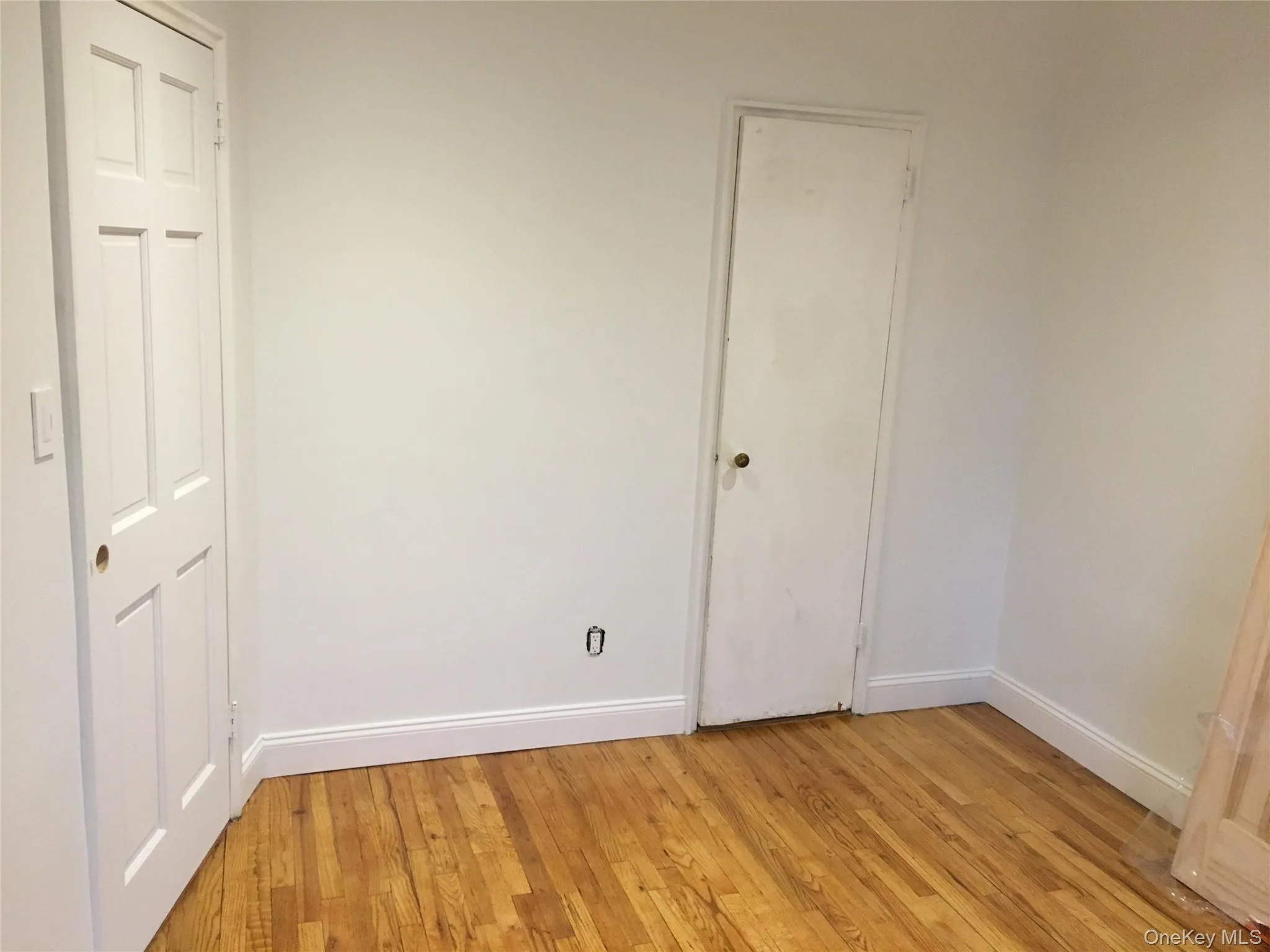 Unfurnished bedroom with light wood-style flooring and baseboards Unfurnished bedroom with light wood-style flooring and baseboards