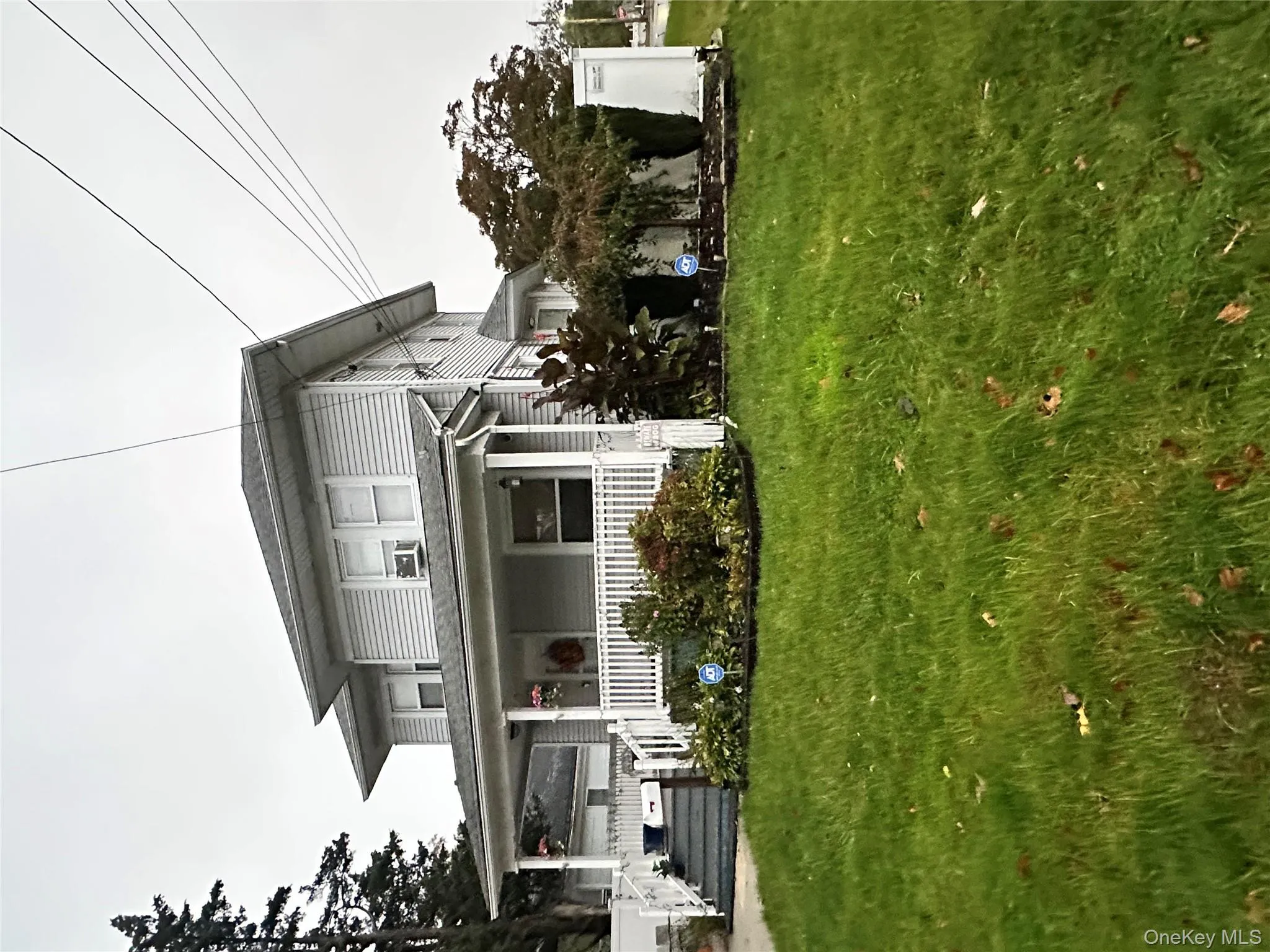 View of front of property featuring covered porch and a front lawn View of front of property featuring covered porch and a front lawn
