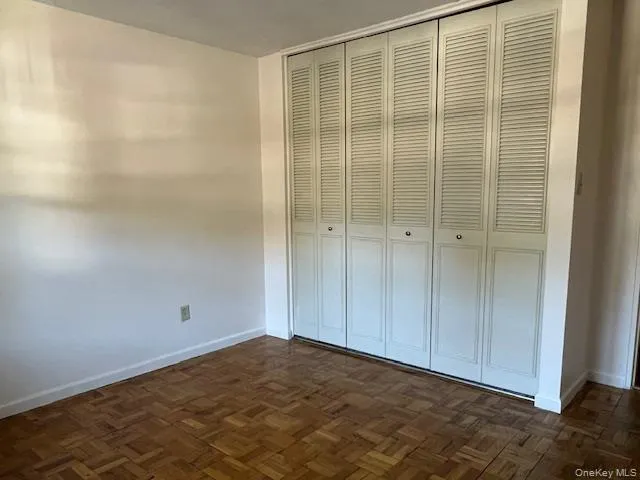 Unfurnished bedroom with baseboards and a closet Unfurnished bedroom with baseboards and a closet