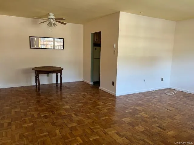 Unfurnished room featuring baseboards and ceiling fan Unfurnished room featuring baseboards and ceiling fan