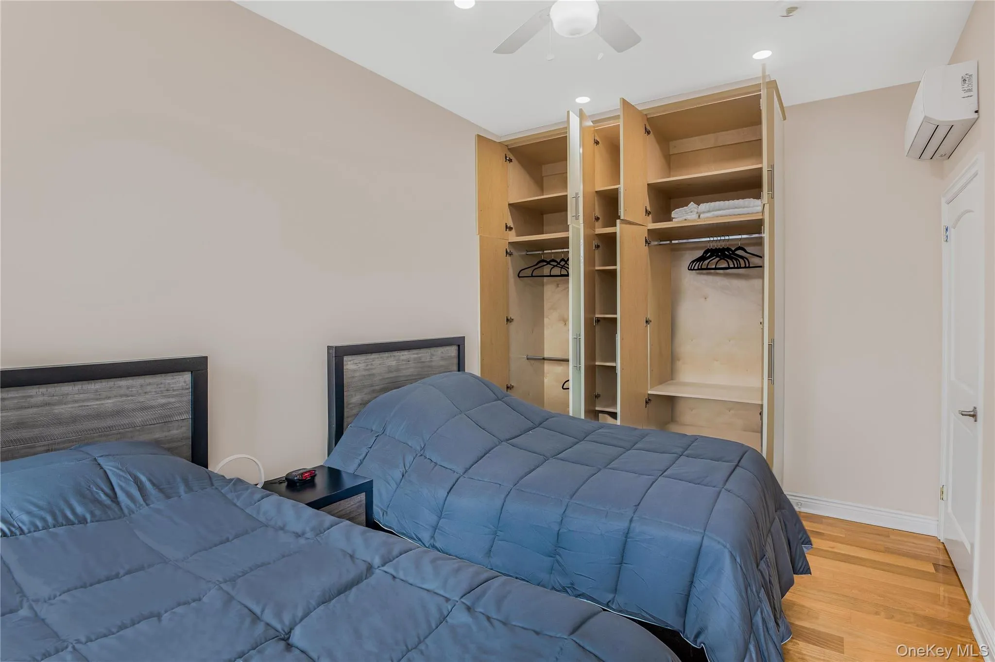 Bedroom #3 with light wood-style floors, an AC wall unit, a ceiling fan, recessed lighting, and a closet Bedroom #3 with light wood-style floors, an AC wall unit, a ceiling fan, recessed lighting, and a closet
