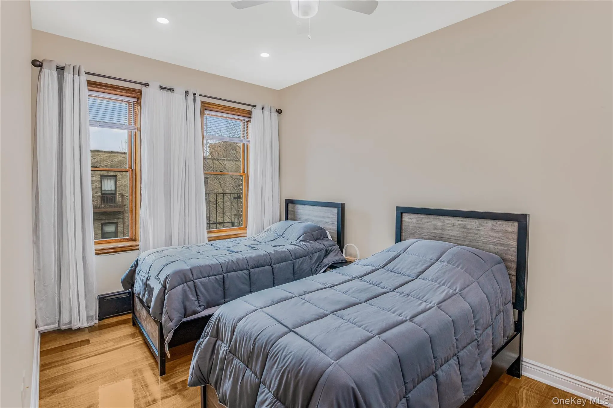 Furnished Bedroom #3 featuring light wood finished floors, a ceiling fan, and recessed lighting Furnished Bedroom #3 featuring light wood finished floors, a ceiling fan, and recessed lighting