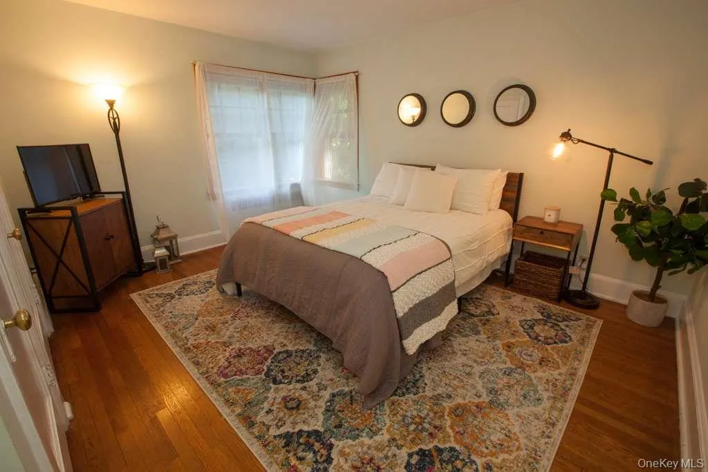 Bedroom with dark wood finished floors Bedroom with dark wood finished floors