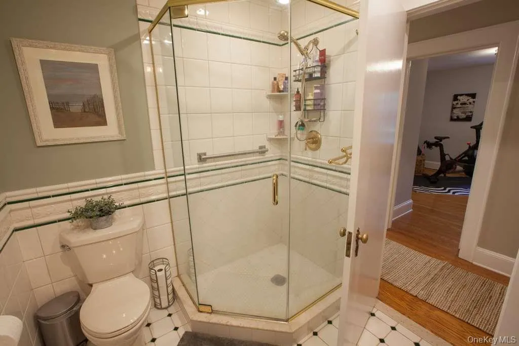 Bathroom featuring a stall shower and wood finished floors Bathroom featuring a stall shower and wood finished floors