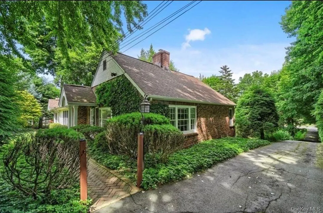 View of property exterior featuring brick siding, roof with shingles, and a chimney View of property exterior featuring brick siding, roof with shingles, and a chimney