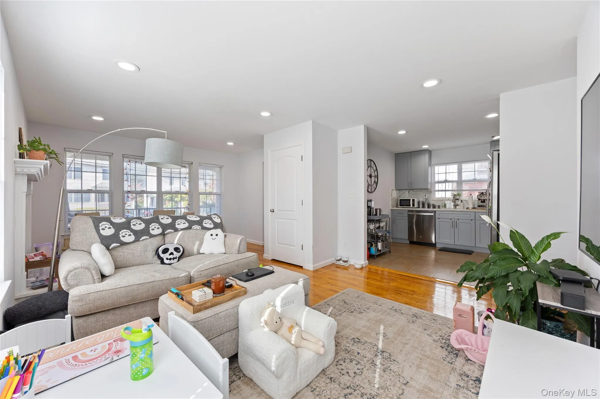 Living room with light wood-style flooring and recessed lighting Living room with light wood-style flooring and recessed lighting