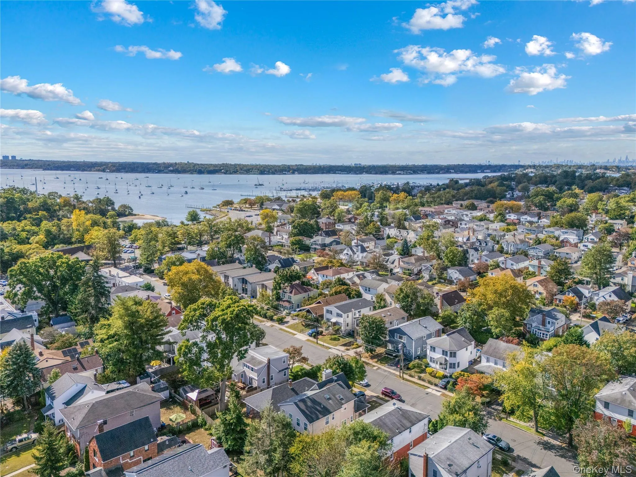 Aerial perspective of suburban area with a large body of water Aerial perspective of suburban area with a large body of water