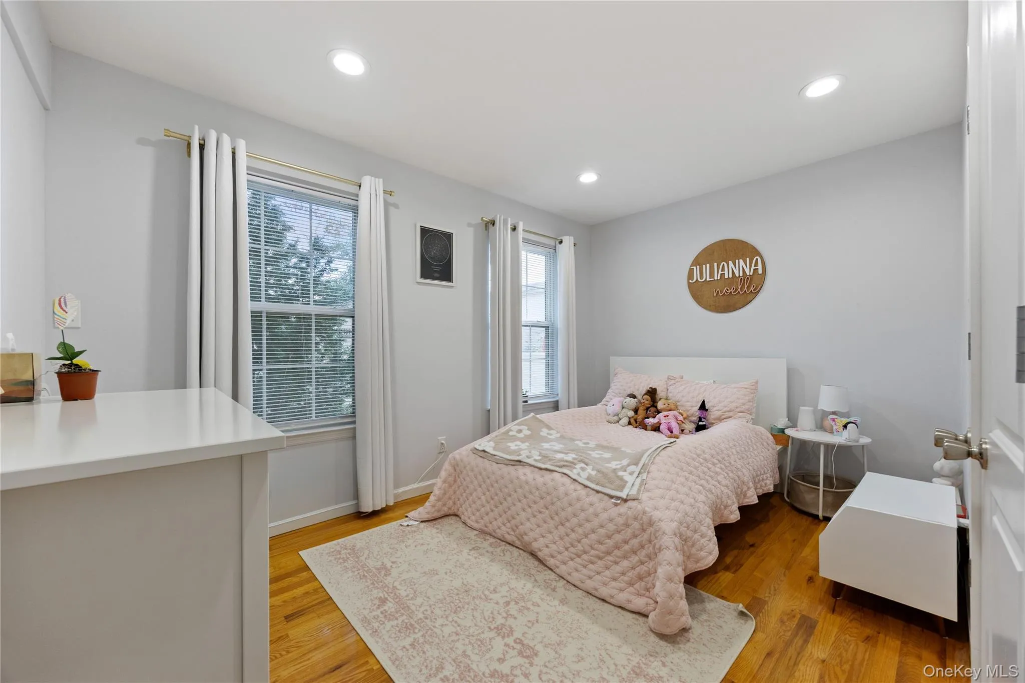 Bedroom with light wood-style flooring and recessed lighting Bedroom with light wood-style flooring and recessed lighting