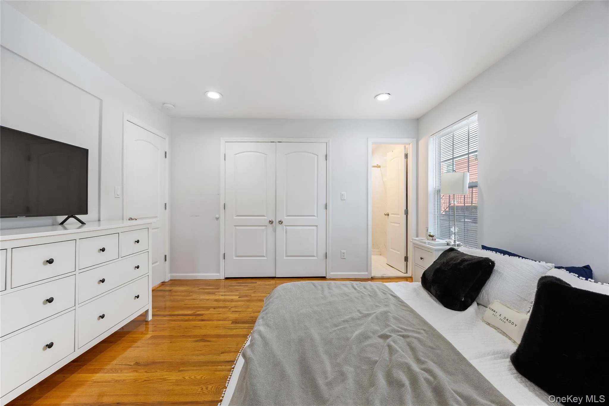 Bedroom featuring light wood-type flooring, recessed lighting, ensuite bathroom, and a closet Bedroom featuring light wood-type flooring, recessed lighting, ensuite bathroom, and a closet