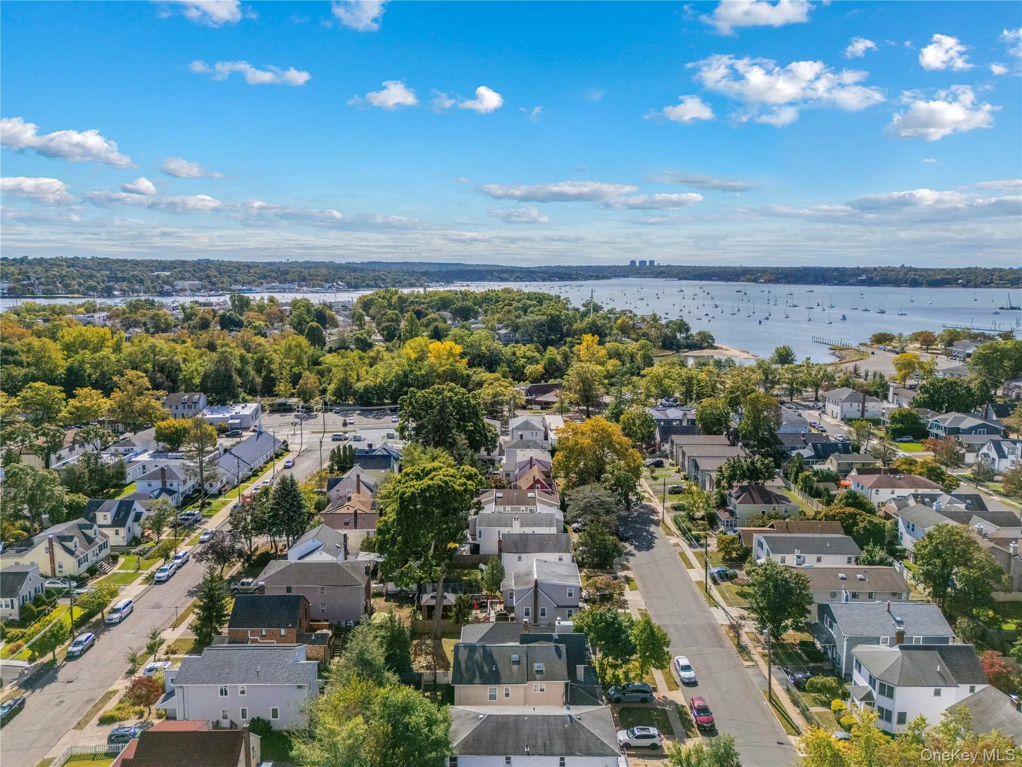 Aerial perspective of suburban area with a nearby body of water Aerial perspective of suburban area with a nearby body of water
