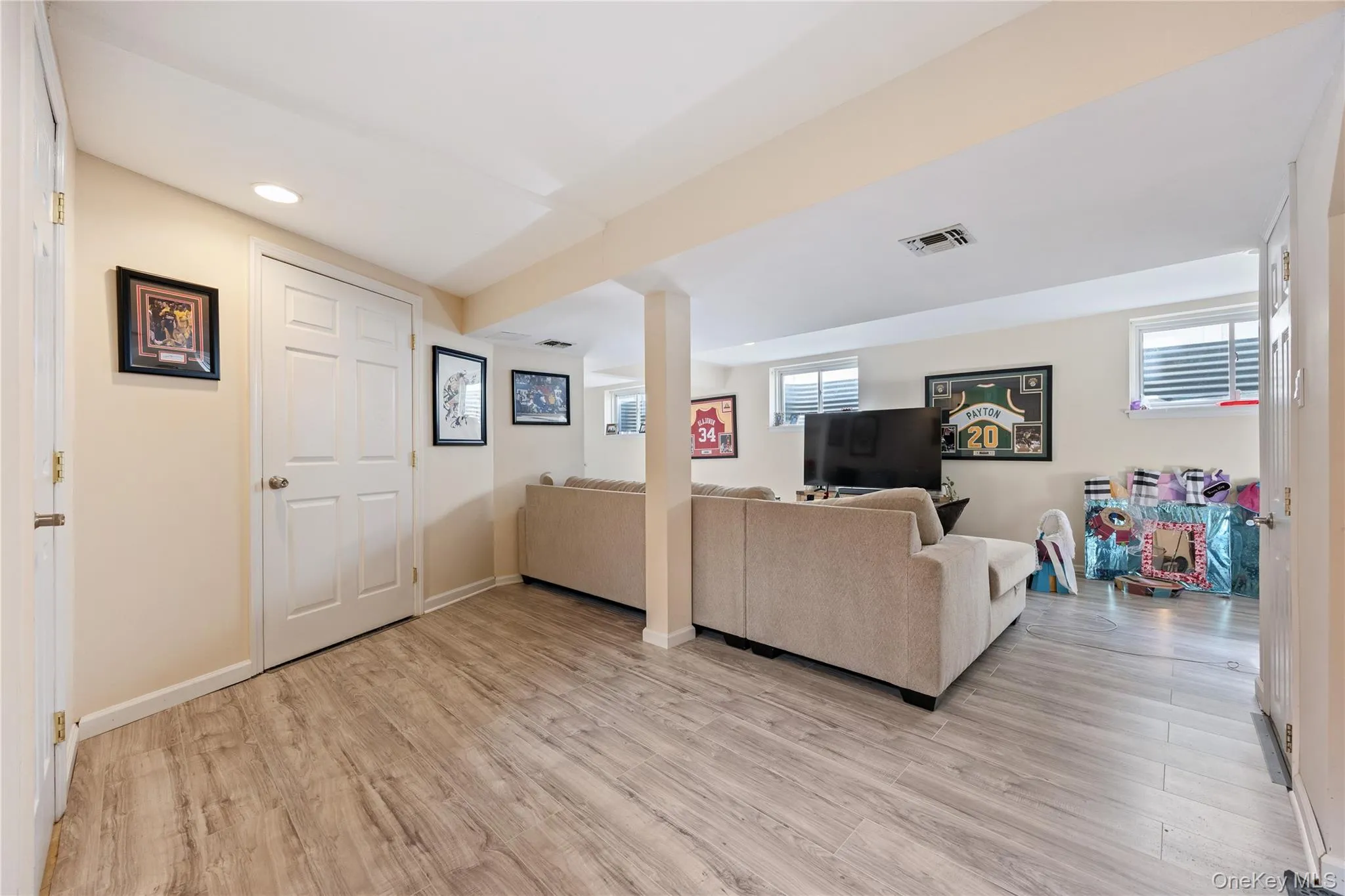 Living room featuring light wood-style floors and recessed lighting Living room featuring light wood-style floors and recessed lighting