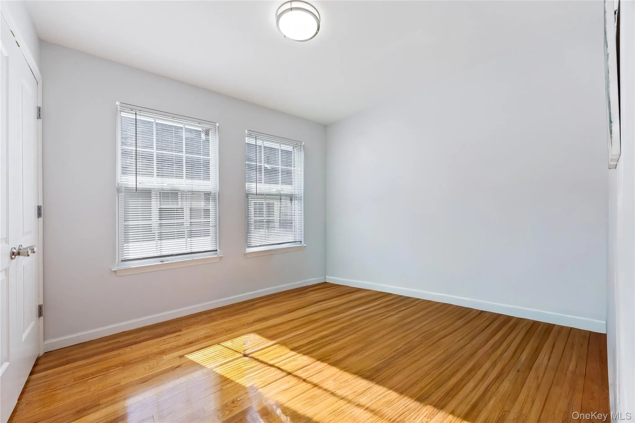 Spare room featuring baseboards and light wood finished floors Spare room featuring baseboards and light wood finished floors
