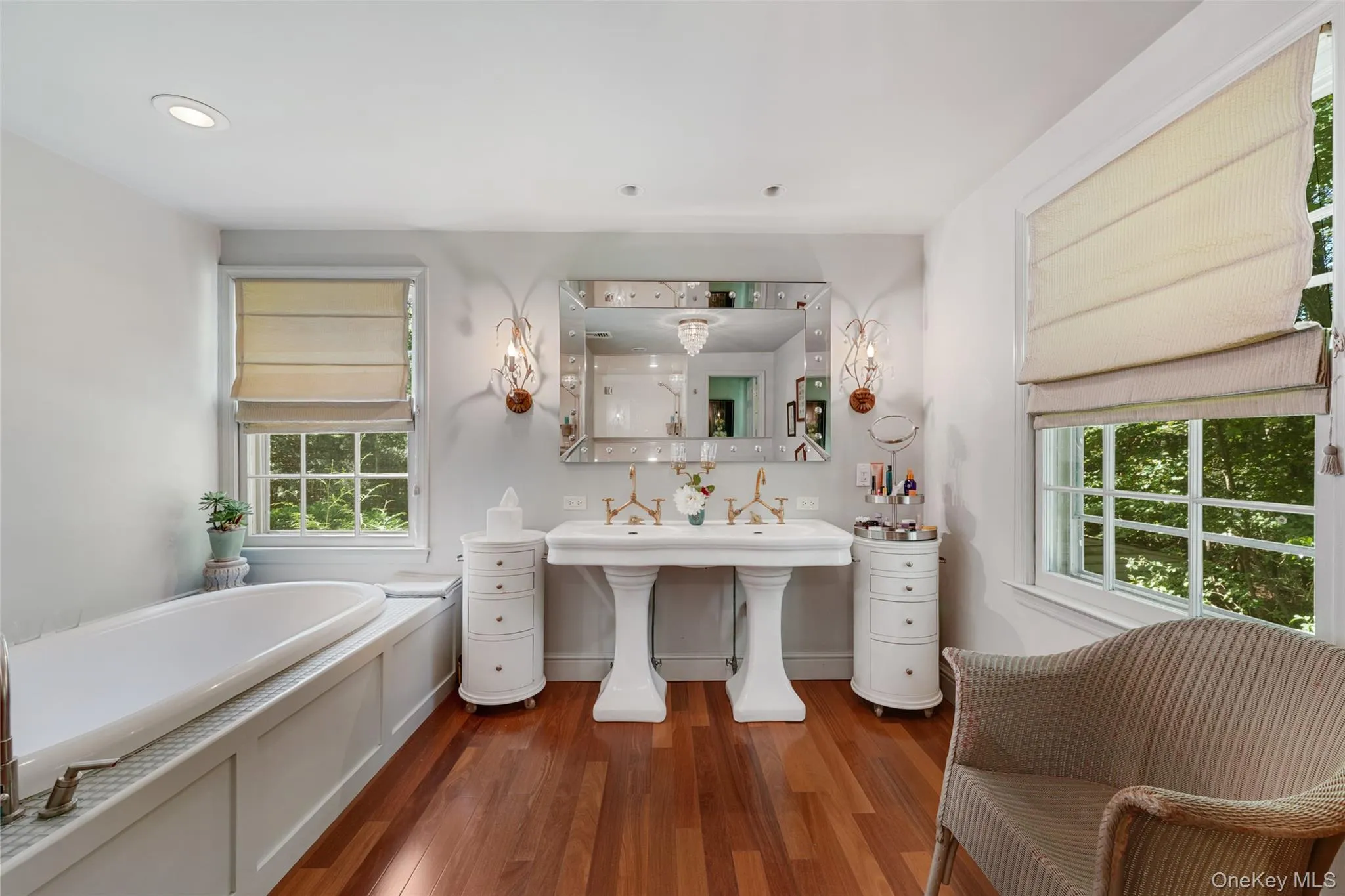 Bathroom featuring a bath, recessed lighting, and wood finished floors Bathroom featuring a bath, recessed lighting, and wood finished floors