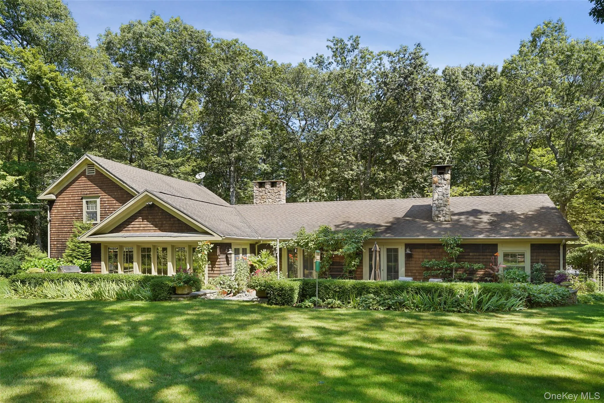 View of front of property with a front lawn and a chimney View of front of property with a front lawn and a chimney