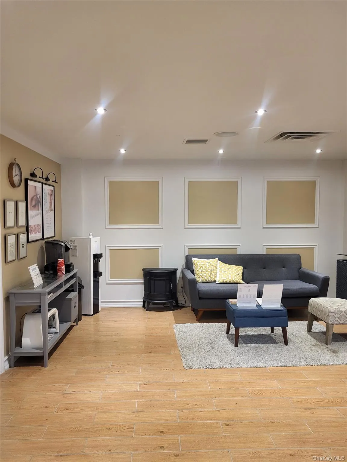 Living area featuring a wood stove, light wood-style floors, and recessed lighting Living area featuring a wood stove, light wood-style floors, and recessed lighting