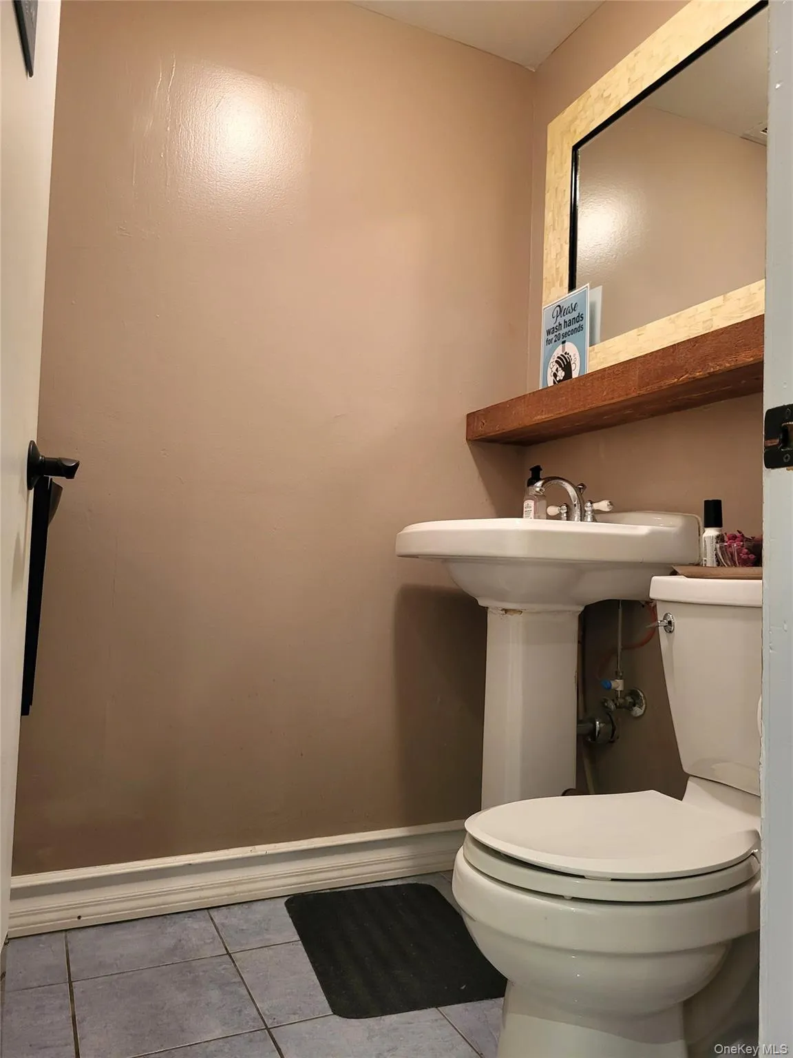 Bathroom with light tile patterned floors and baseboards Bathroom with light tile patterned floors and baseboards