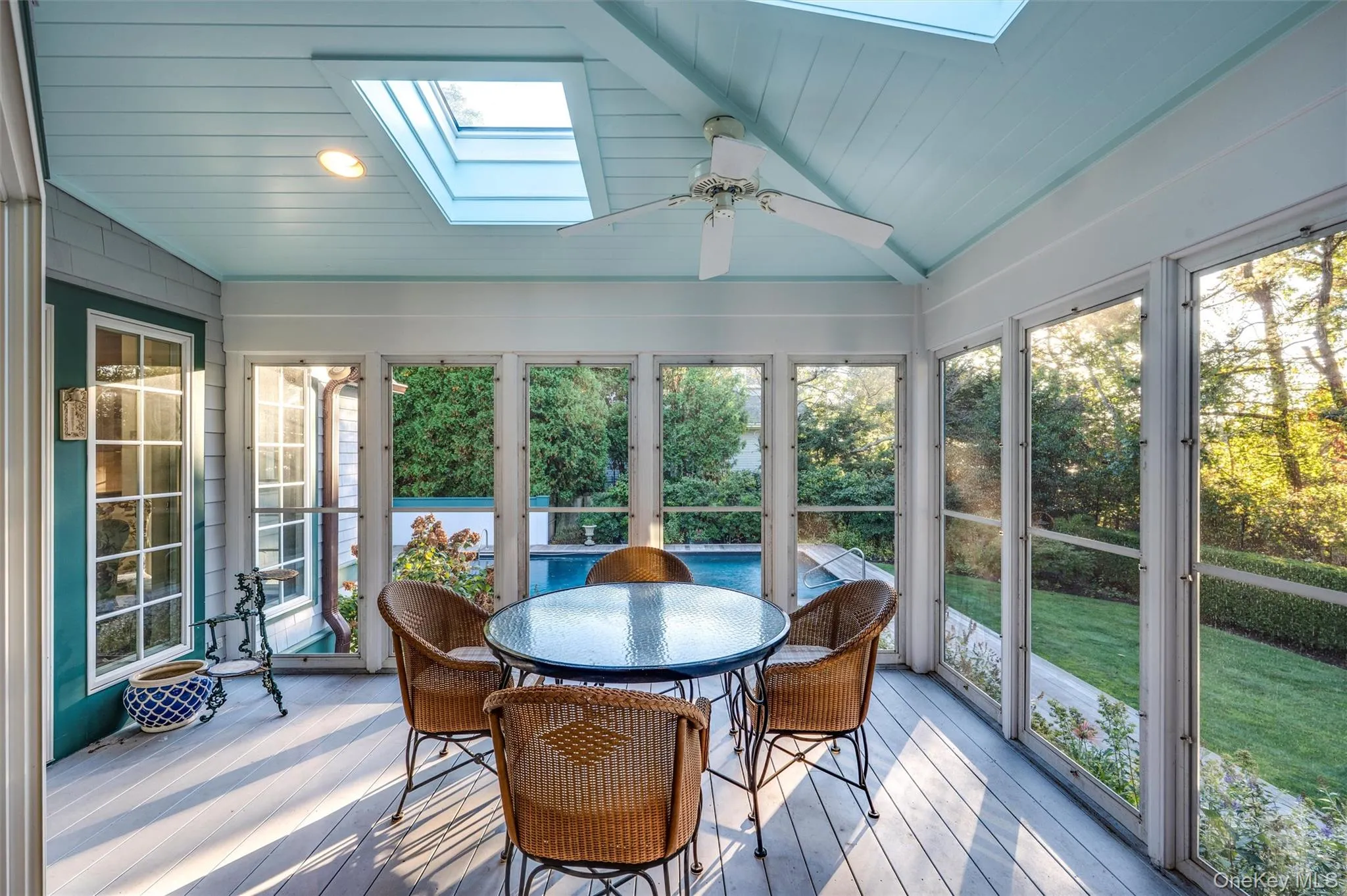 Sunroom featuring a skylight, outdoor dining area, ceiling fan, and lofted ceiling Sunroom featuring a skylight, outdoor dining area, ceiling fan, and lofted ceiling