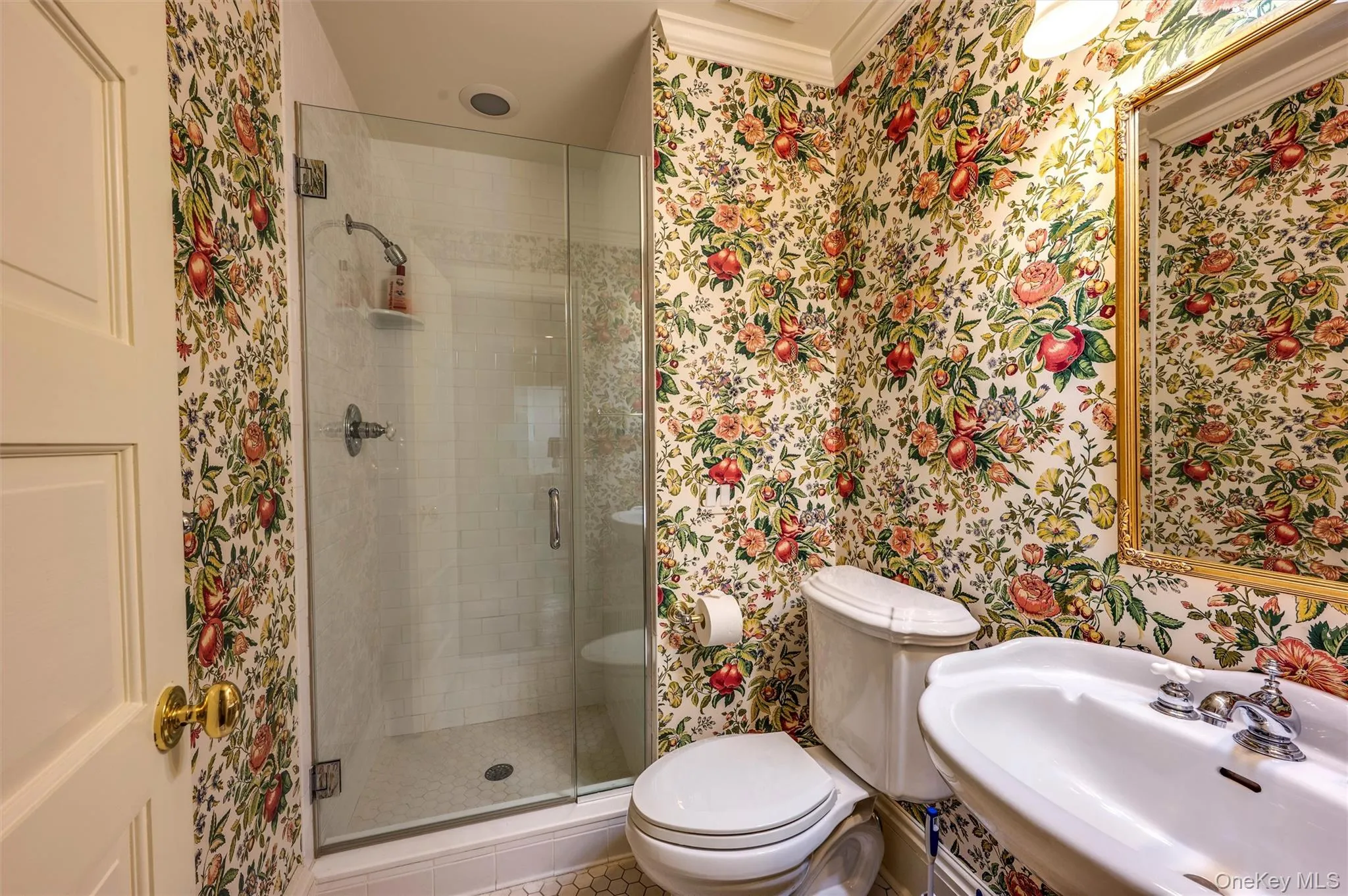 Bathroom featuring wallpapered walls, a stall shower, and tile patterned floors Bathroom featuring wallpapered walls, a stall shower, and tile patterned floors