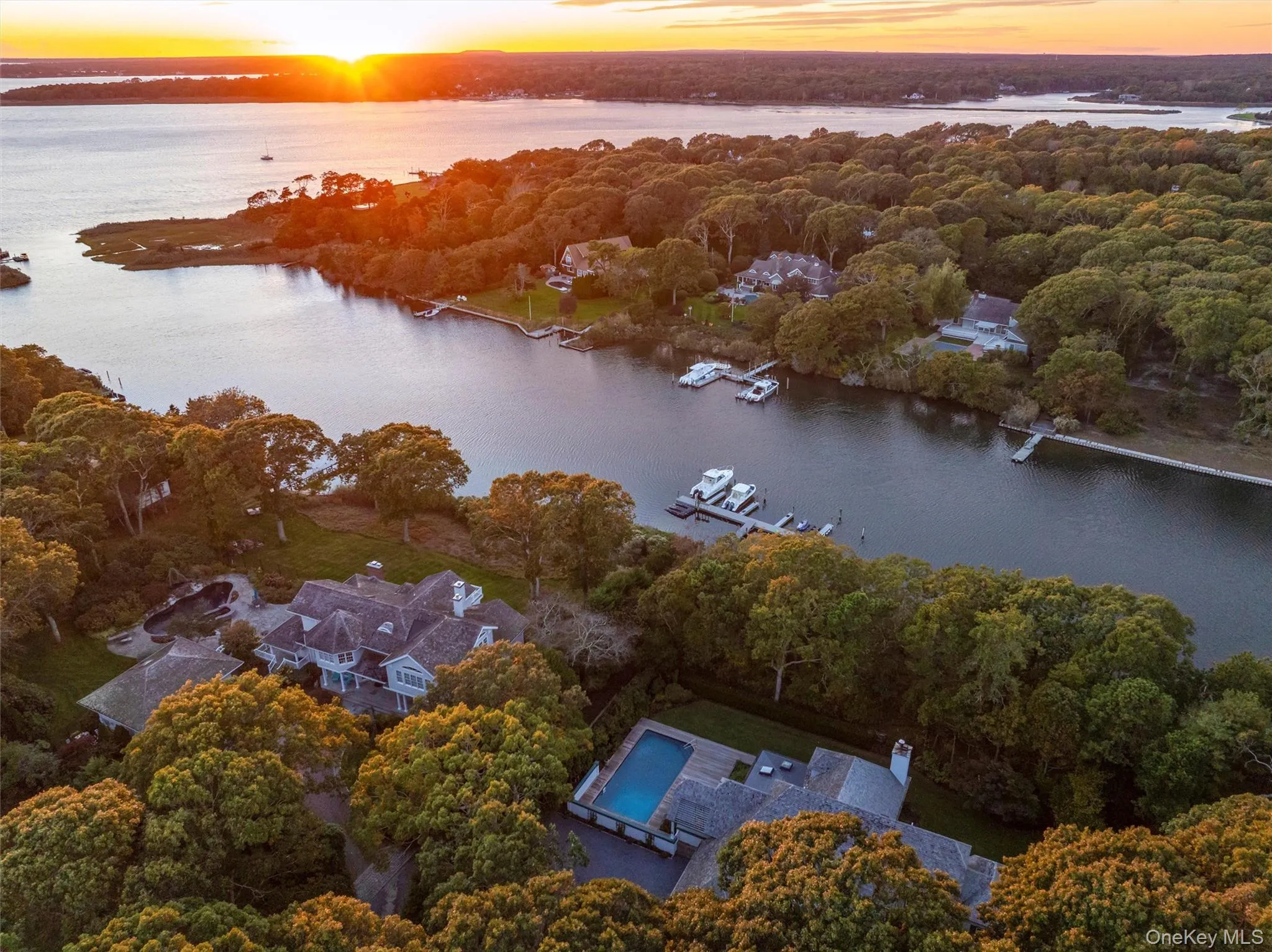Aerial view at dusk of a forest view and a water view Aerial view at dusk of a forest view and a water view