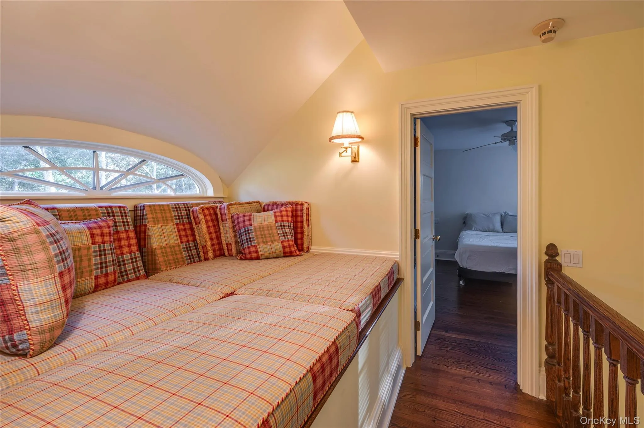 Bedroom featuring vaulted ceiling, dark wood finished floors, and a walk in closet Bedroom featuring vaulted ceiling, dark wood finished floors, and a walk in closet