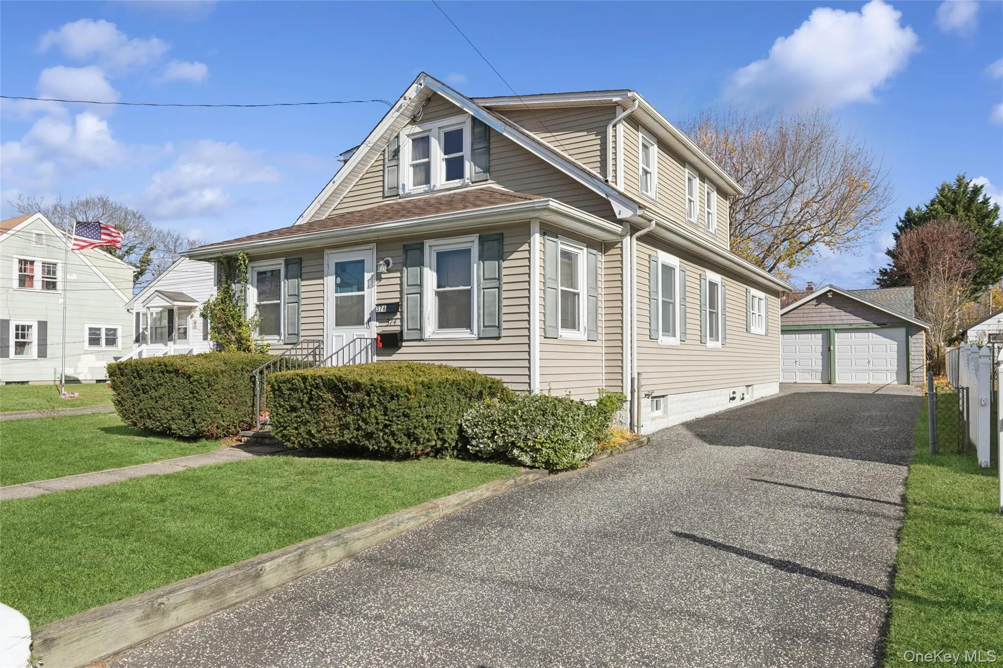 Bungalow-style house featuring an outbuilding, a front lawn, and a detached garage Bungalow-style house featuring an outbuilding, a front lawn, and a detached garage