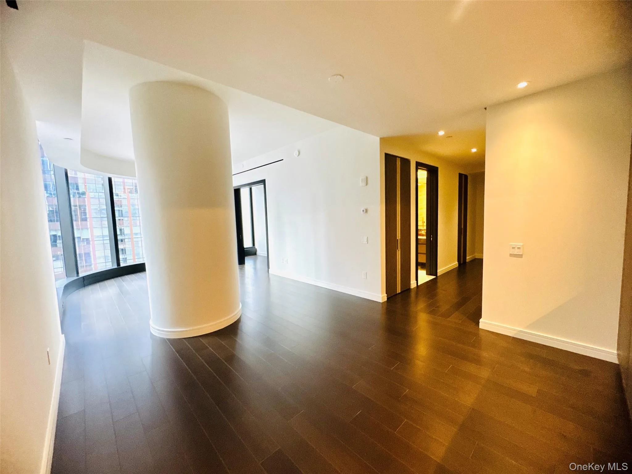 Unfurnished room featuring dark wood-style flooring and recessed lighting Unfurnished room featuring dark wood-style flooring and recessed lighting