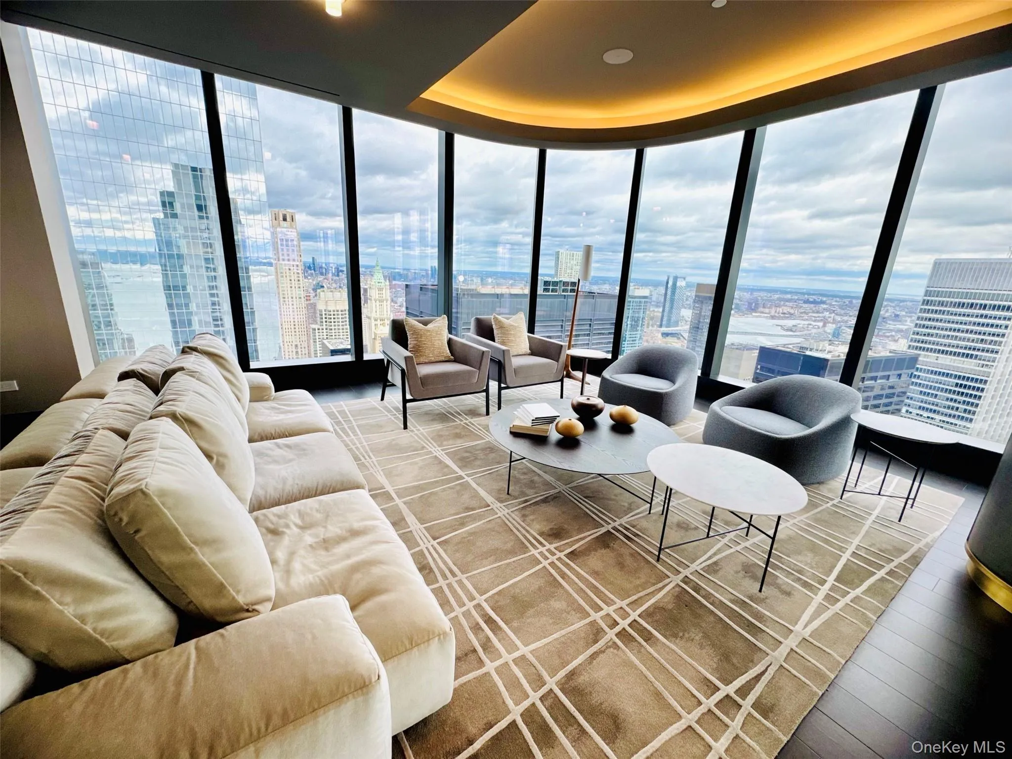 Living area with expansive windows, a view of city, healthy amount of natural light, and light wood-style flooring Living area with expansive windows, a view of city, healthy amount of natural light, and light wood-style flooring