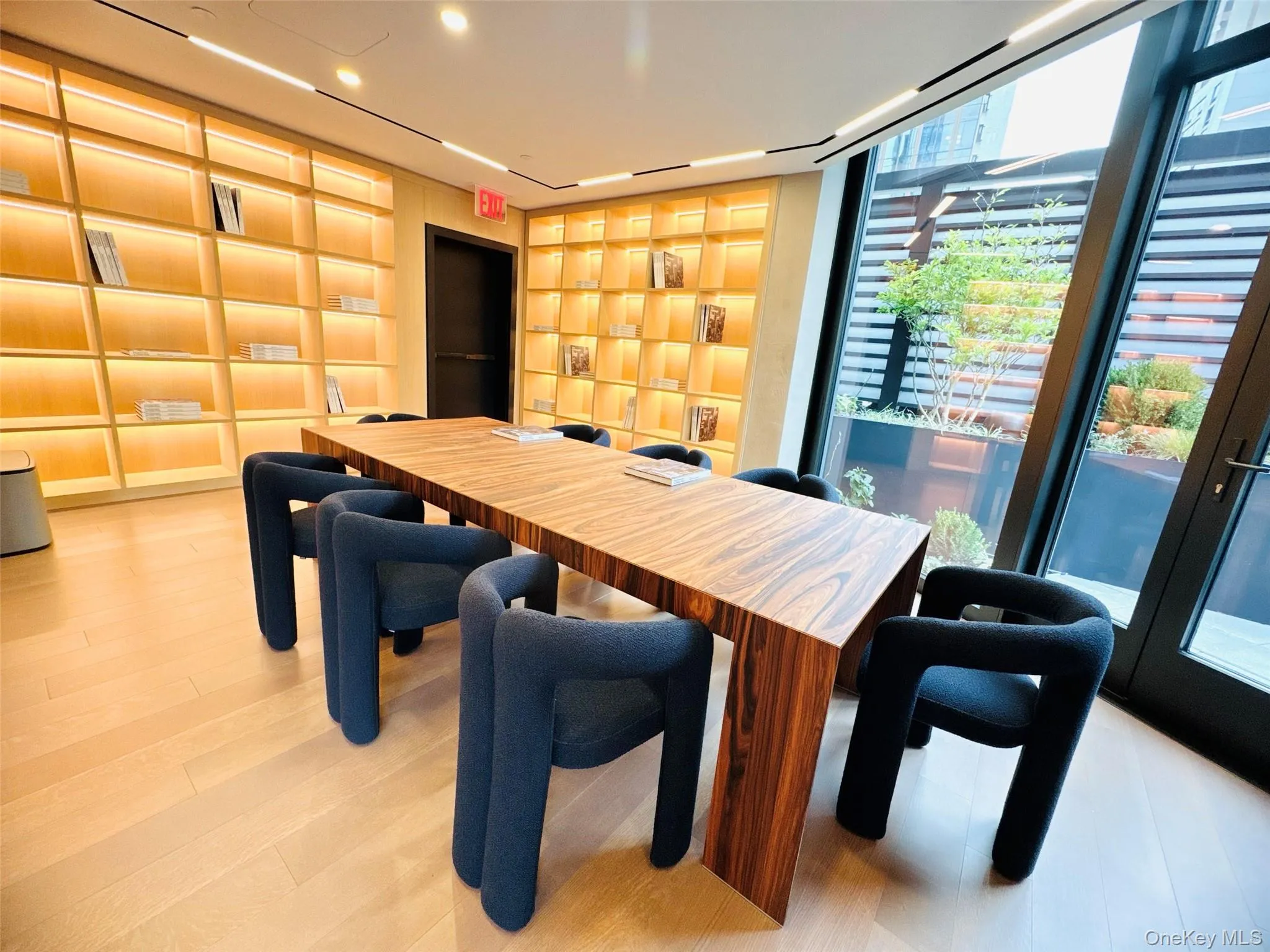Dining area featuring light wood-style flooring and expansive windows Dining area featuring light wood-style flooring and expansive windows