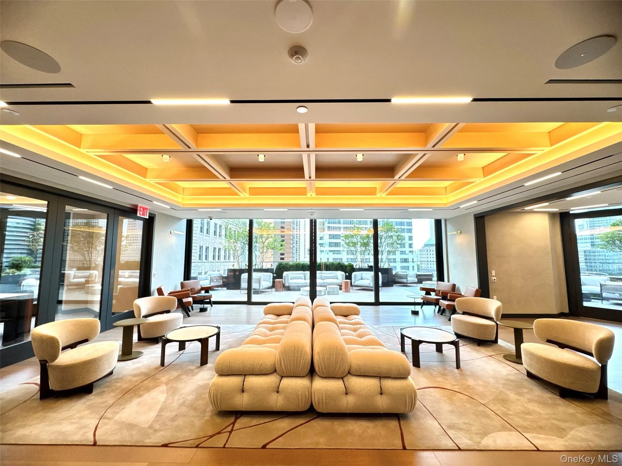 Common area with coffered ceiling, a wall of windows, and beam ceiling Common area with coffered ceiling, a wall of windows, and beam ceiling