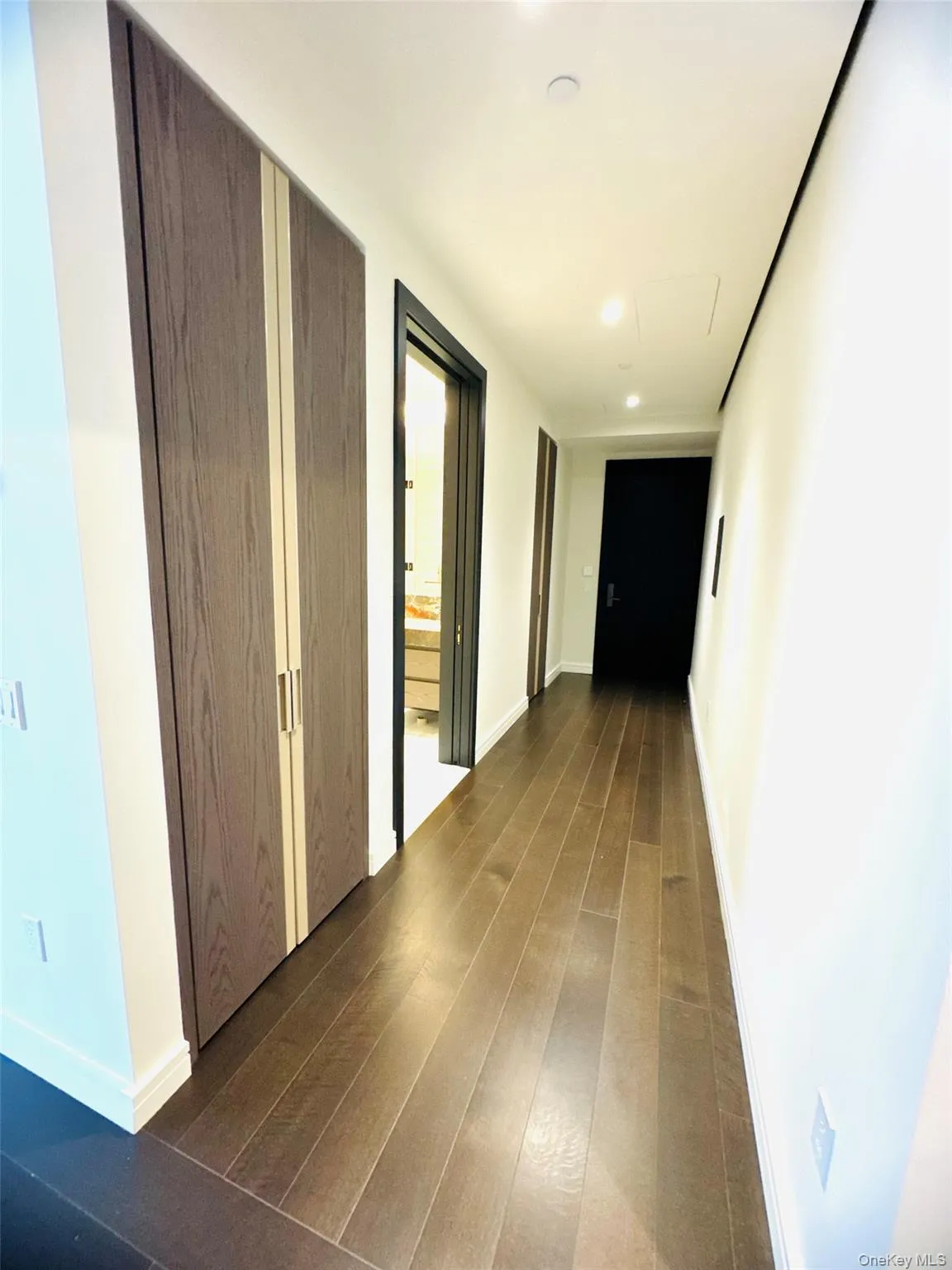 Hall featuring dark wood-style flooring and recessed lighting Hall featuring dark wood-style flooring and recessed lighting