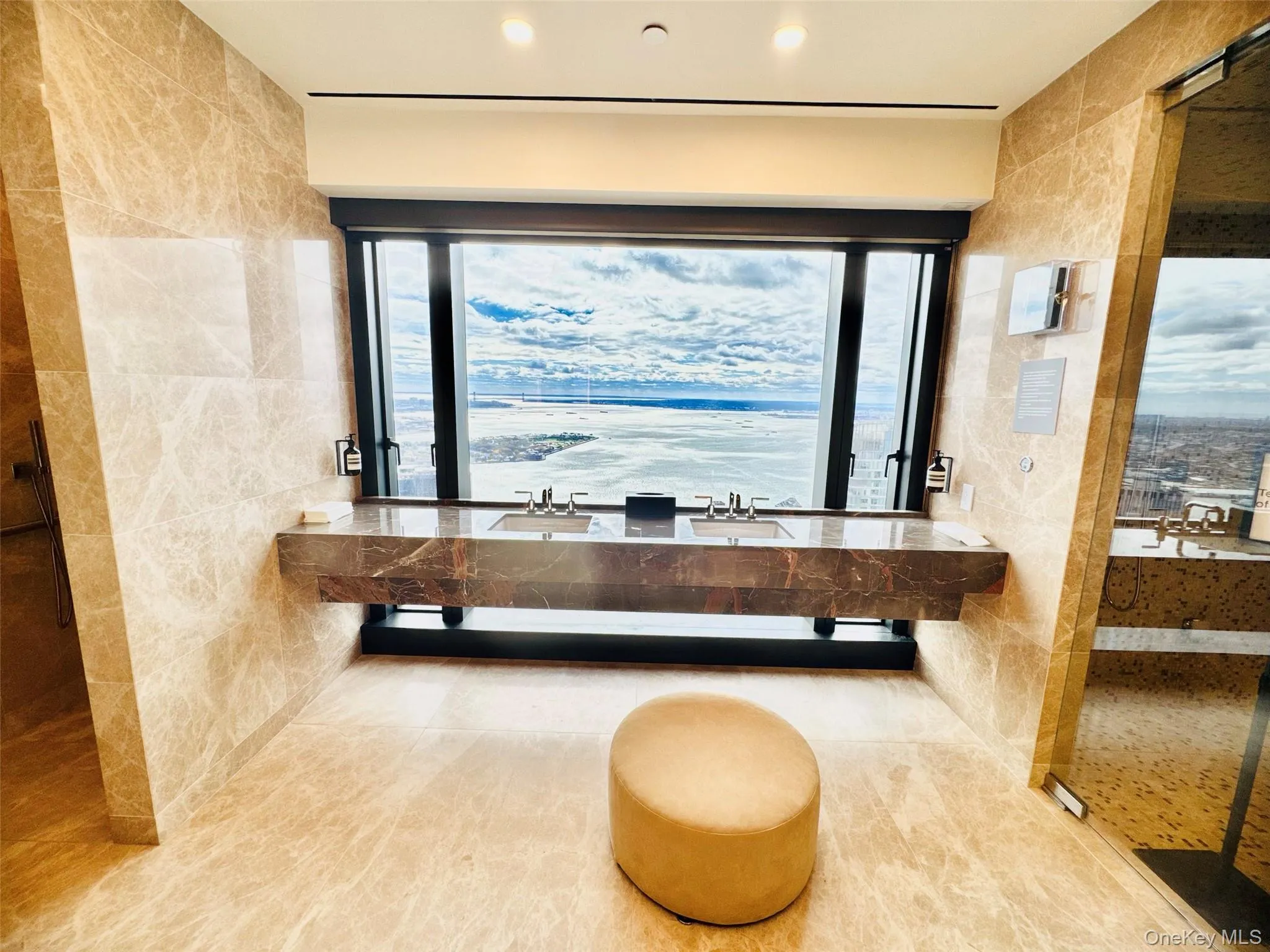 Full bath featuring tile walls, double vanity, and plenty of natural light Full bath featuring tile walls, double vanity, and plenty of natural light