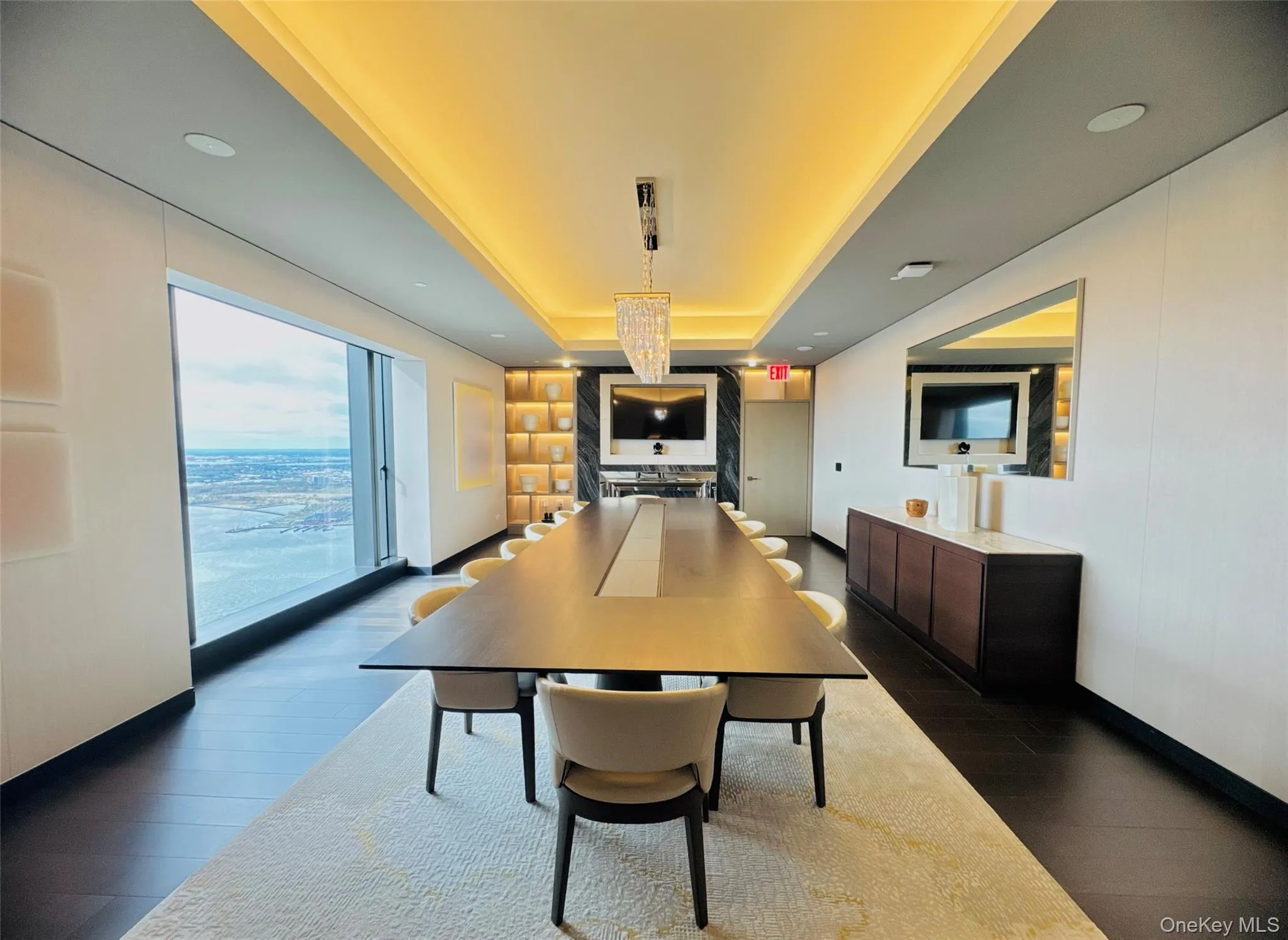 Dining space with a raised ceiling and dark wood-type flooring Dining space with a raised ceiling and dark wood-type flooring